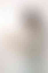 Mother with newborn baby during a newborn session in Guelph, Ontario, captured in a natural light studio setting