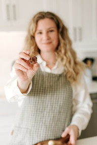 Emily from Cocoa Beau Chocolate creating handcrafted chocolates during a branding session in a home kitchen in Guelph, Ontario.