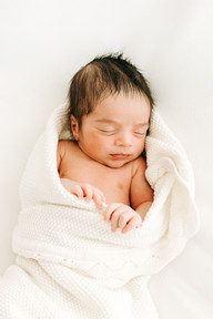 Newborn baby wrapped in a swaddle during a studio newborn photography session