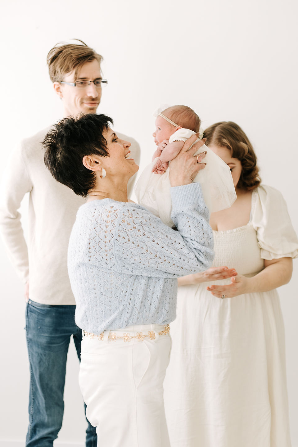 Extended family including grandma, mom, dad, and newborn baby during a newborn session in Guelph, Ontario