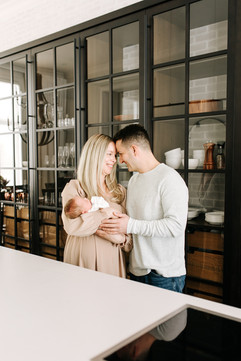 In-home newborn session in a kitchen space capturing everyday moments in Guelph, Ontario