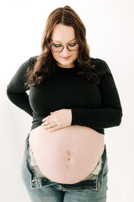 Studio maternity session in Guelph, Ontario highlighting mom and her baby bump in soft lighting