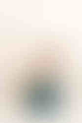 Baby boy turns one, enjoying his first birthday cake smash session in a classic jean overall outfit.