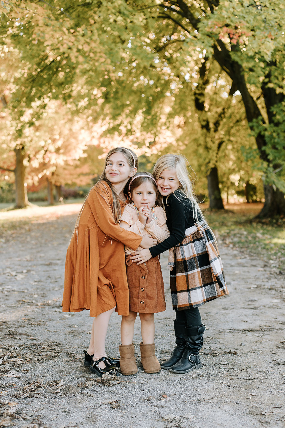 Sisters posing together during their fall family session at The Guelph Arboretum