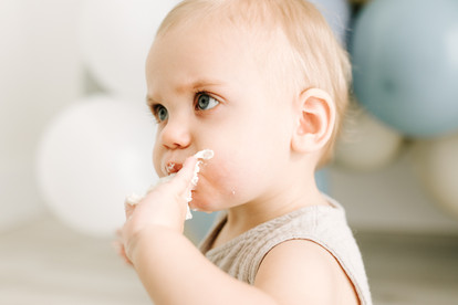 Emerson during his first birthday cake smash at Elle Chic Photography Studio, Guelph, wearing a neutral studio wardrobe outfit.