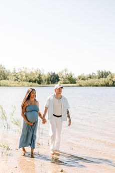 Beach maternity session in Guelph, Ontario featuring expecting parents in coordinated blue and white outfits at Guelph Lake Conservation Area