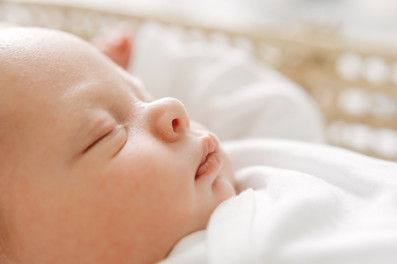 Newborn baby lying in a softly lit room during an in-home newborn session in Guelph, Ontario