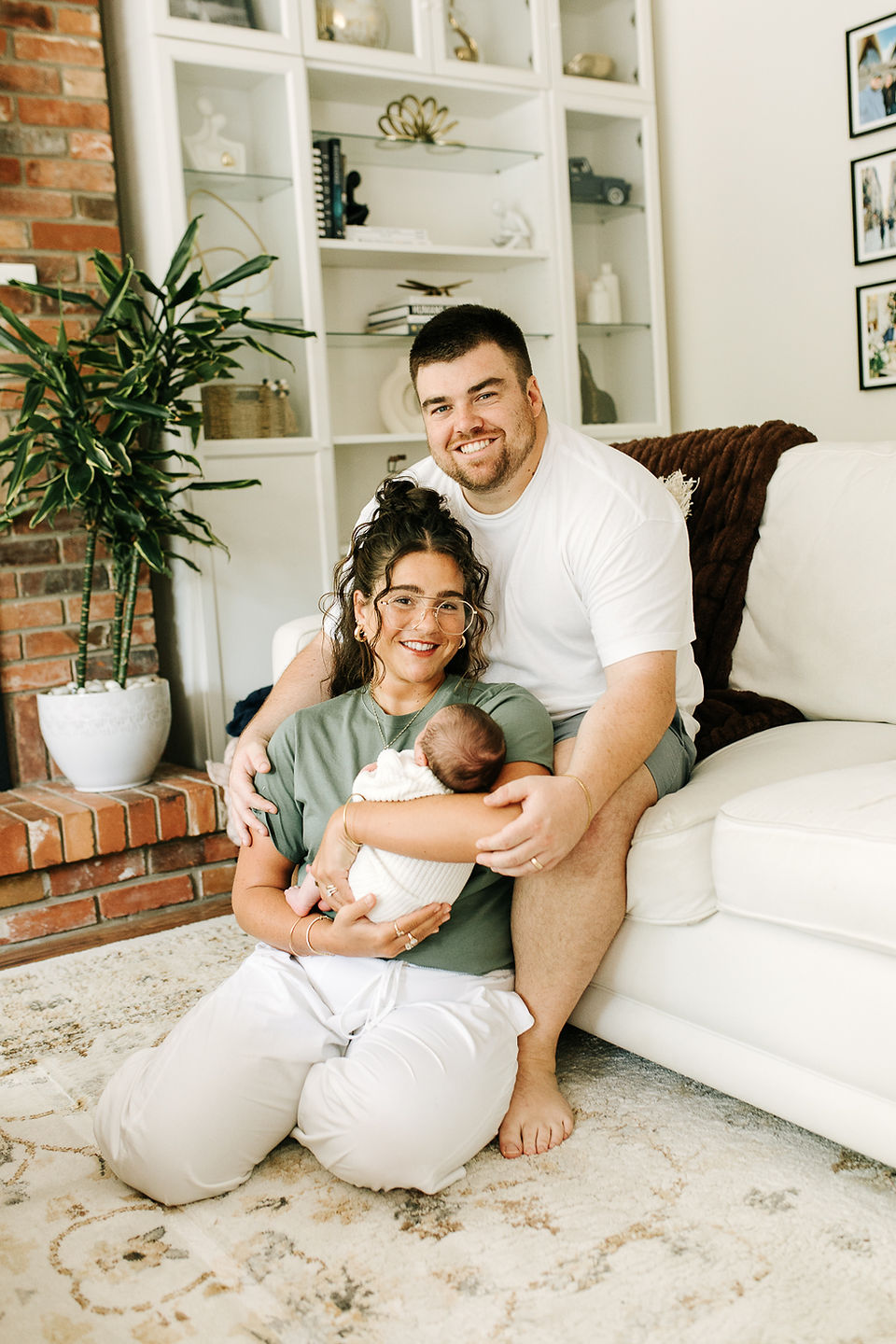 Family newborn photography in Guelph, Ontario capturing a natural embrace between parents and their newborn baby