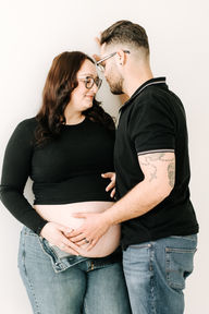 Mom and dad-to-be during a maternity session in Guelph, Ontario, capturing a quiet moment before welcoming their new baby.