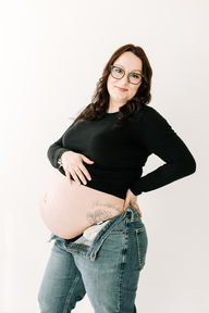 Studio maternity session in Guelph, Ontario highlighting mom and her baby bump in soft lighting