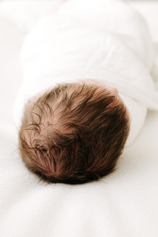Newborn baby head and hair detail during a newborn session in Guelph, Ontario captured in a soft, airy portrait