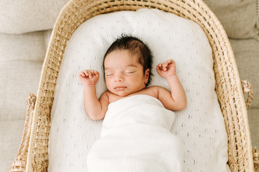 Newborn baby wrapped in a swaddle during a studio newborn photography session