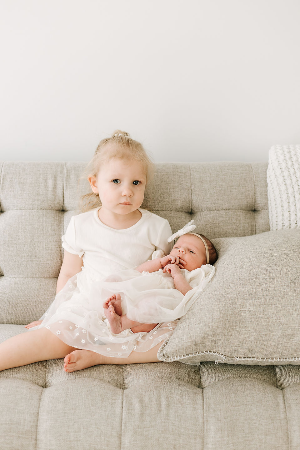 Sibling moment between toddler and newborn baby during a newborn session in Guelph, Ontario