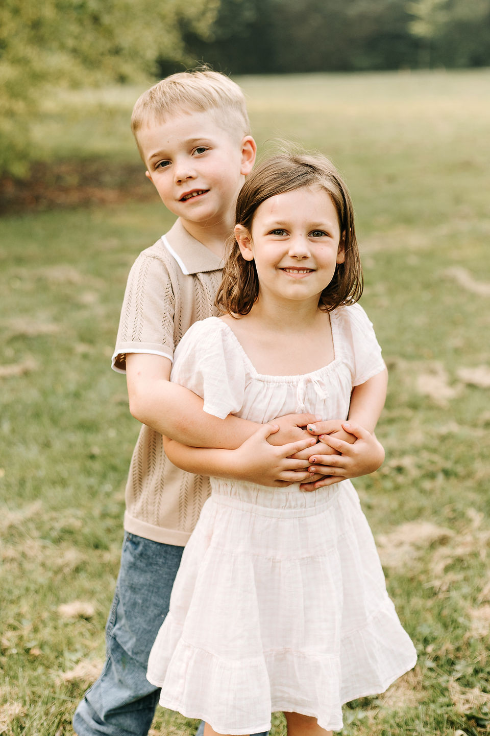 Young cousins posing together during an extended family photography session at The Guelph Arboretum in Guelph, Ontario.