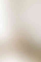 Mother holding newborn baby in a bedroom during an in-home newborn session in Guelph, Ontario