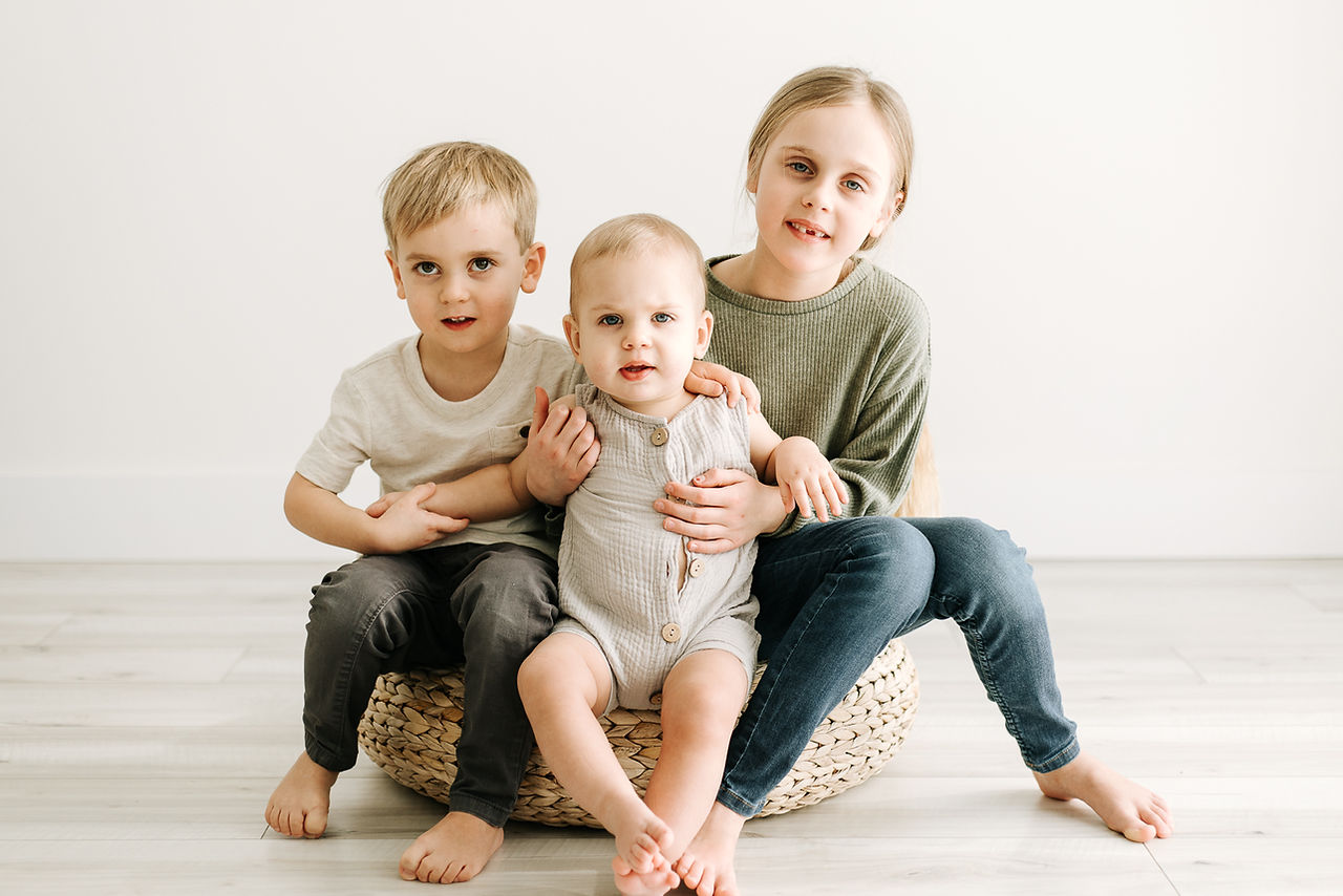 Siblings during first birthday cake smash at Elle Chic Photography Studio, Guelph, Ontario.