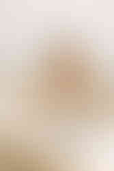 Big sister interacting with newborn baby during a newborn session in Guelph, Ontario, soft studio portrait