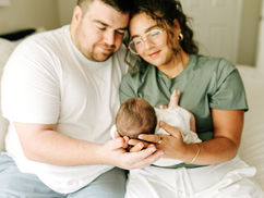 Family newborn photography in Guelph, Ontario capturing a loving moment between parents and their newborn at home