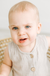 Emerson during his first birthday cake smash at Elle Chic Photography Studio, Guelph, wearing a neutral studio wardrobe outfit.