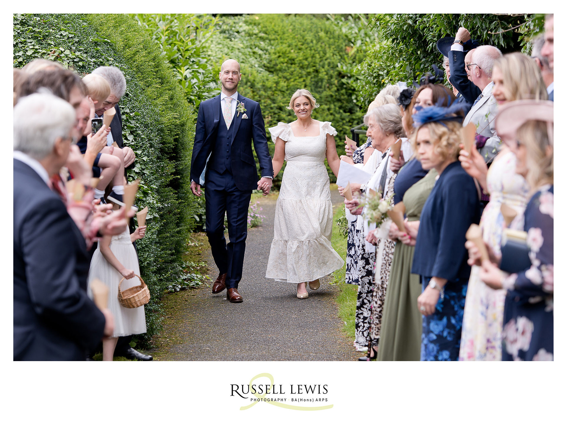 couple walk through confetti
