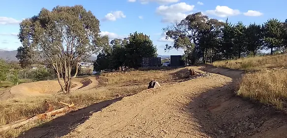 Dual-purpose access road terrace earthworks for vehicle travel and farm water harvesting, designed by Doc Spice Permaculture