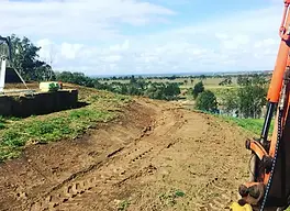 Sloped land terrace earthworks for site access and water retention, designed and executed by Doc Spice Permaculture in Sydney
