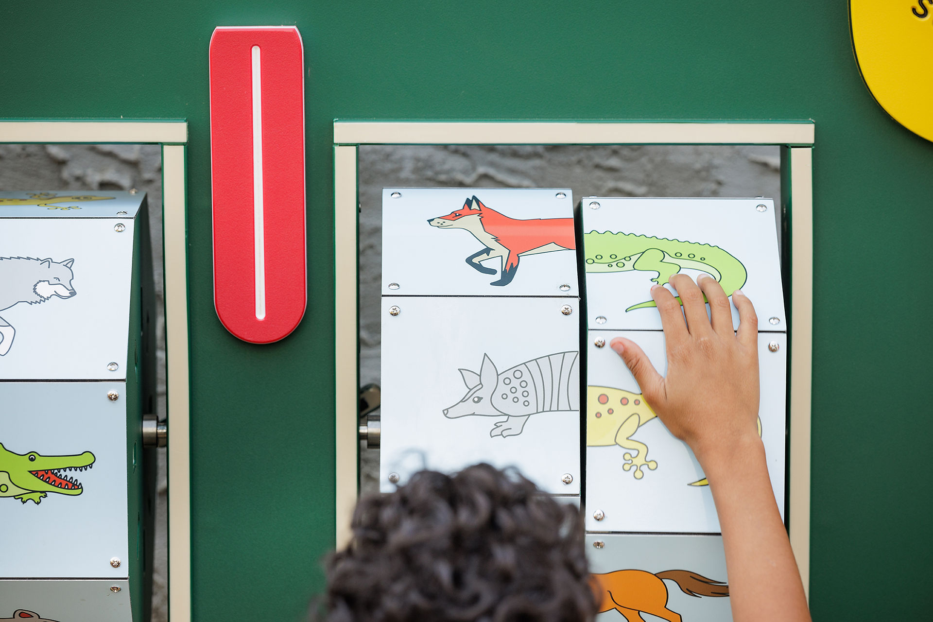 Close up of a boys hand moving the animal spinner.