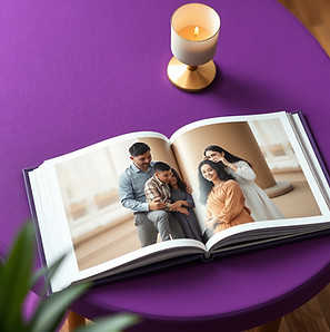 TOP VIEW OPEN FAMILY PHOTOBOOK ON A PREMIUM LUXURY PURPLE TABLE.jpg