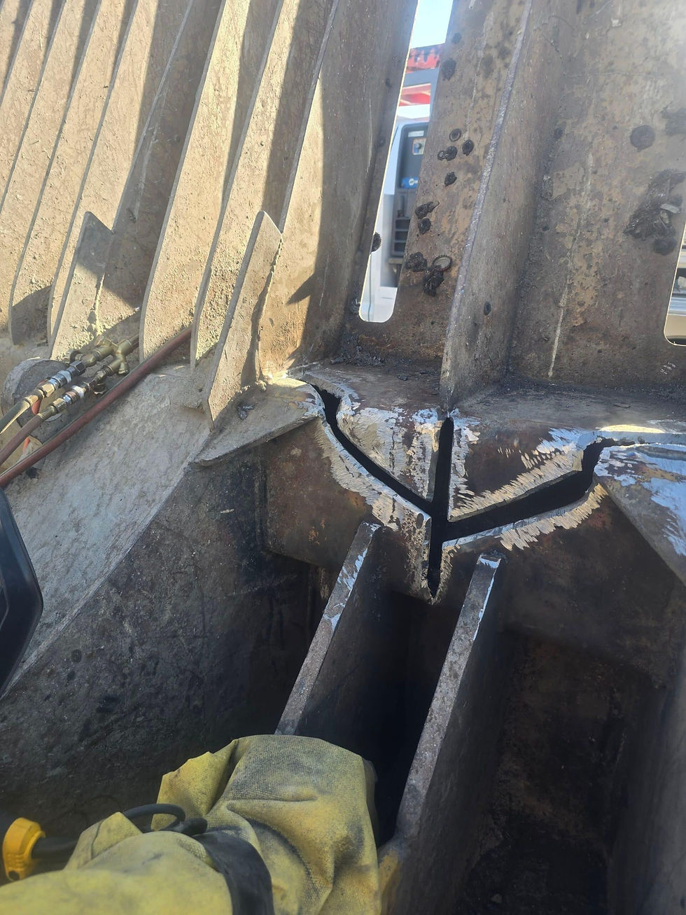 Ground-out crack on a steel compactor part, prepped clean and ready for welding