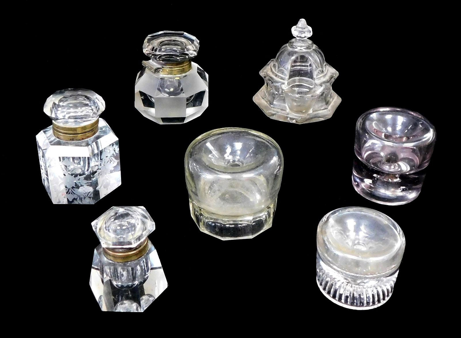 GLASS: Seven clear glass inkwells, c. 1870-1940, including; three non-spill inkw
