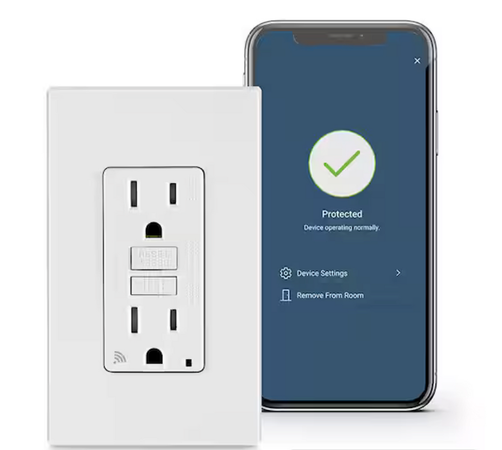 A smart wall outlet beside a smartphone. The phone displays a blue screen with a green checkmark, "Protected," and device settings options.