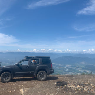 View from Upper Bridal Falls endpoint. Nissan Xterra, dog, firepit, and mountain views.