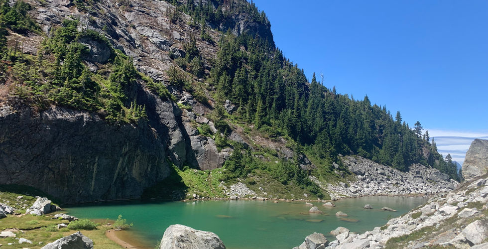 Green Blue alpine lake at end of Silver Peak - Silver Skagit Road overland route.