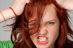 Fashion close-up of a woman with red hair.