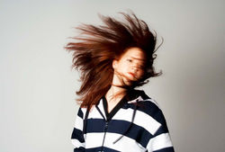 Color fashion portrait of a redheaded woman with flowing hair.