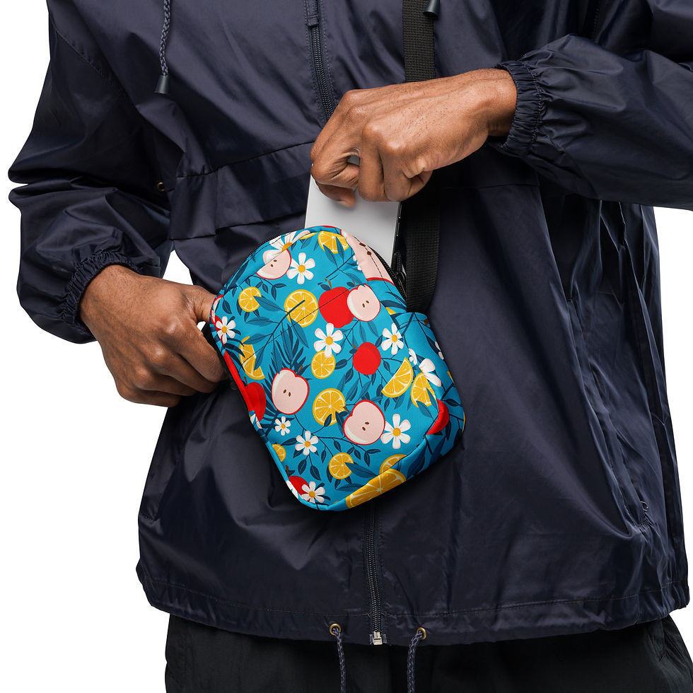 Thumbnail: A bright teal crossbody sling bag featuring a vibrant pattern of red apple slices, yellow citrus wedges, and white daisies.