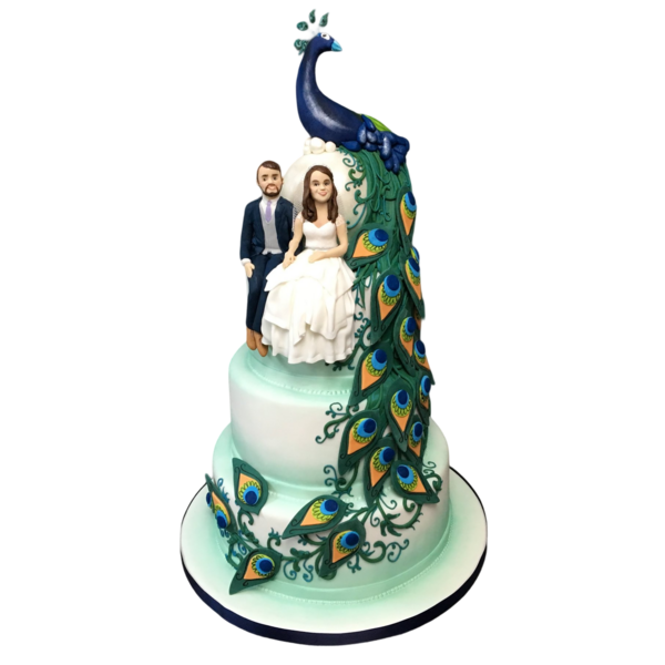Three-tiered wedding cake with peacock theme, sugar couple, and vibrant feathers.
