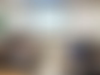 Students in a classroom using laptops, facing a projected presentation on a screen. Whiteboards with notes are visible in the background.