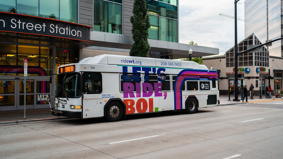 White Valley Regional Transit bus with colorful RIDE, BOLT ad stopped at downtown Street Station; ridevrt.org visible.