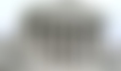 White marble Supreme Court building with columns and statues. Inscription above reads "EQUAL JUSTICE UNDER LAW." Overcast sky.