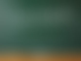 The word "Lawsuit" is written in white chalk on a green chalkboard with an eraser and books on a wooden ledge below.