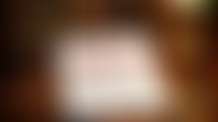 Legal document labeled "UNCONSTITUTIONAL" on a wooden desk with a gavel, scales, glasses, and a green lamp, suggesting a courtroom setting.