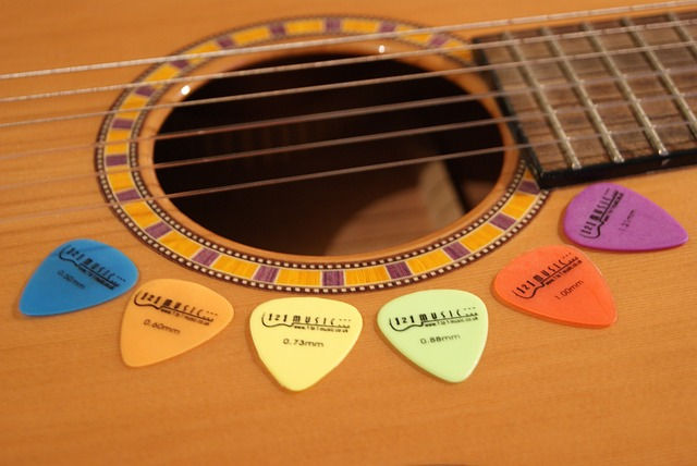 An acoustic guitar with picks around the sound hole