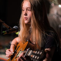 Charlotte performing on guitar at the Greater Toronto Music School recital