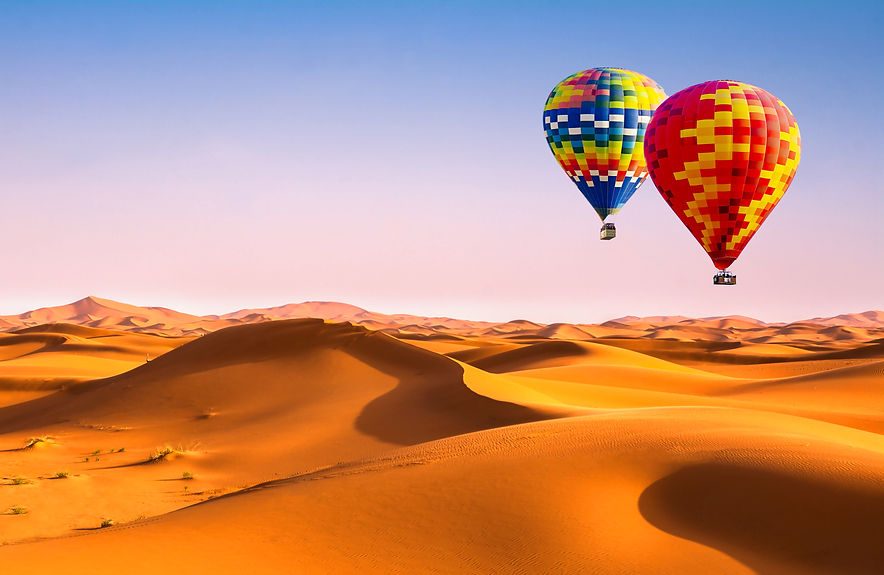 Travel concept. Amazing view of sand dunes with hot air balloons in the Sahara Desert. Loc
