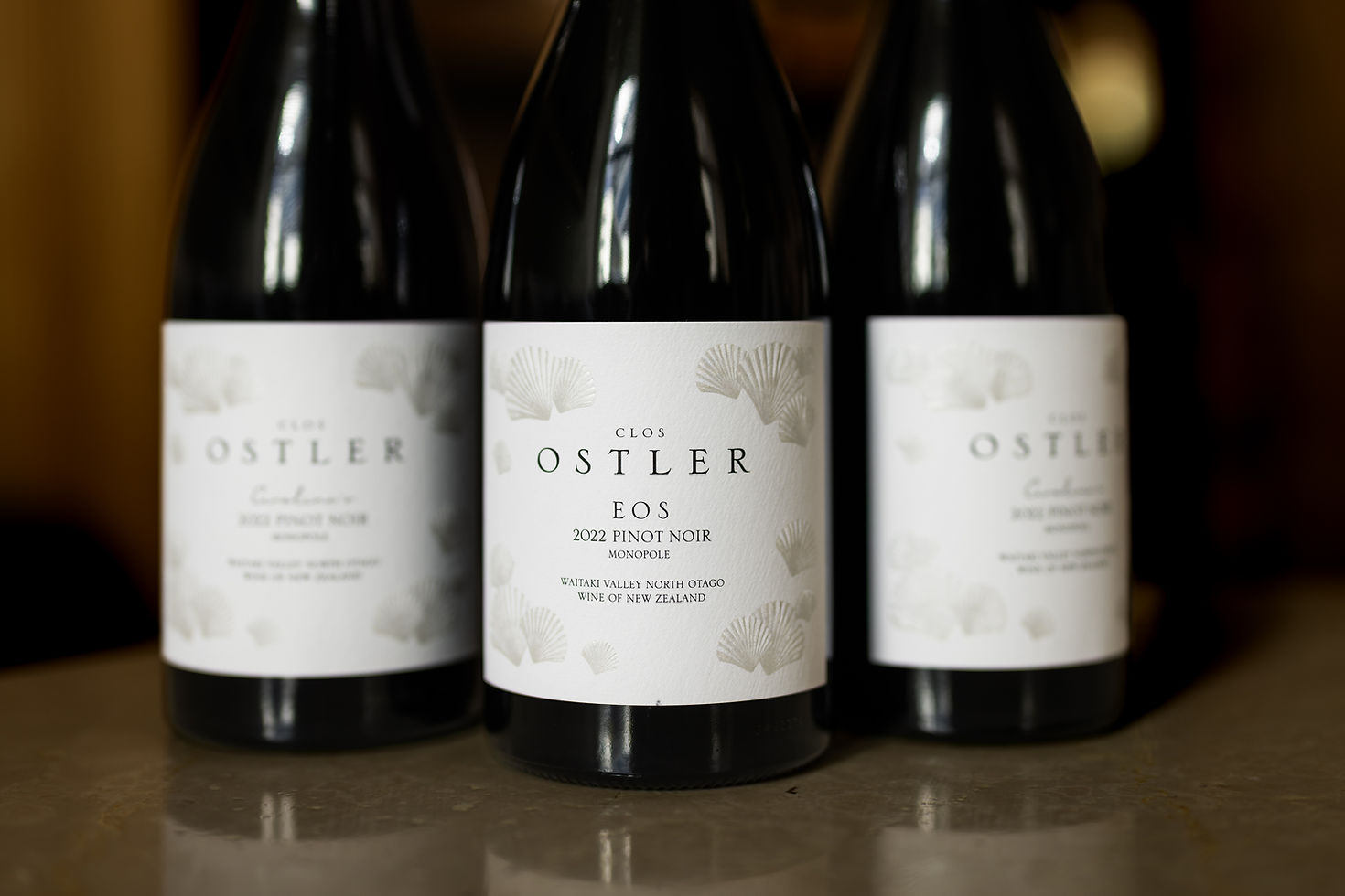 Clos Ostler EOS Pinot Noir 2022 flanked by Caroline’s Pinot Noir bottles.