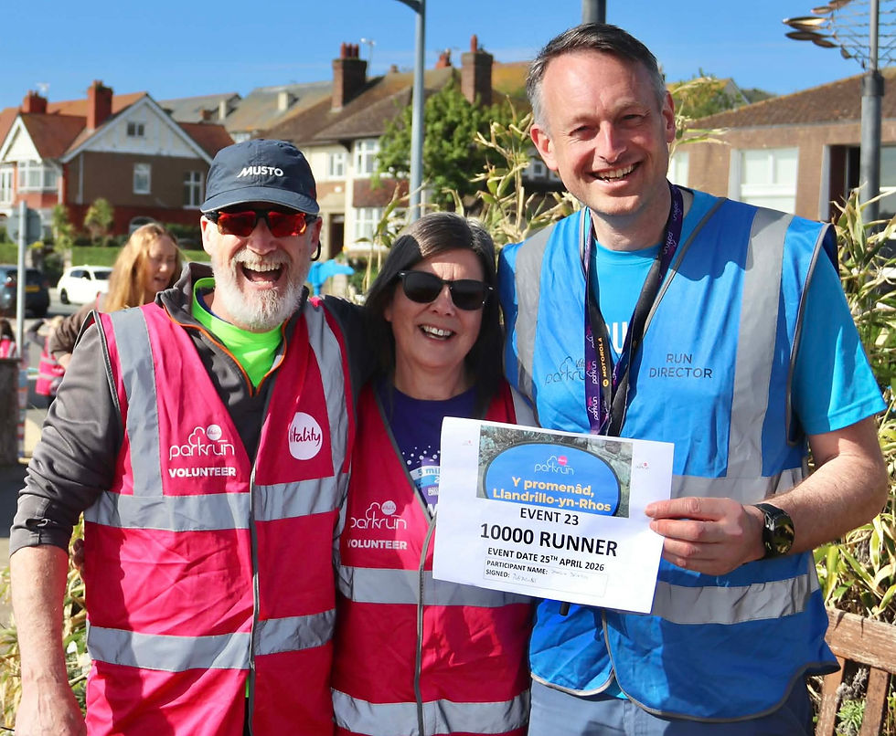 *Pictured above (l-r): Rhos Run Directors' Chris Spillane, Sharon Hughes and Richard Peevor with the amazing 10,000th parkrun landmark certificate, and (below) the commemorative golden token.