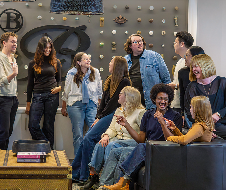 Design B&B team members conversing in the agency's office lobby.