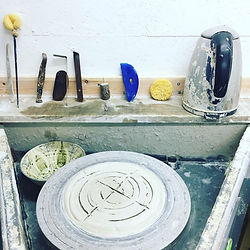 Leach kick wheel with potter's tools lined up ready for use