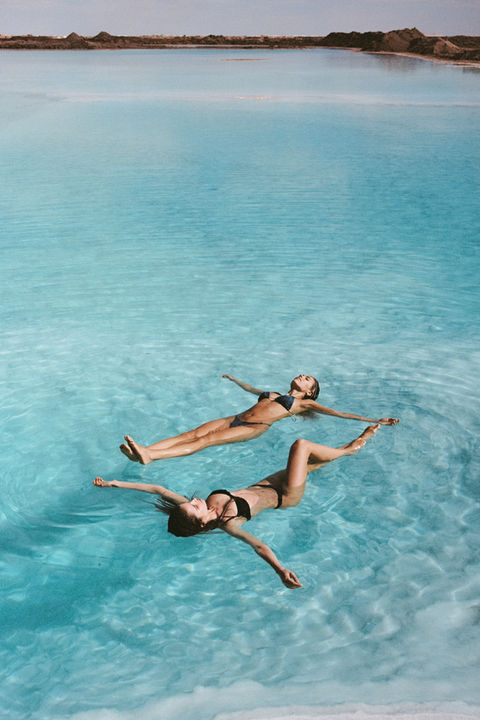 Two women floating on water in Siwa Oasis.